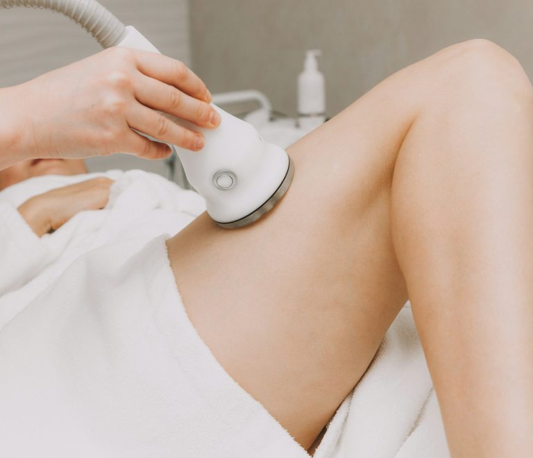 beautician girl doing thigh lift in spa salon. a woman lies in a spa salon on a body lift.