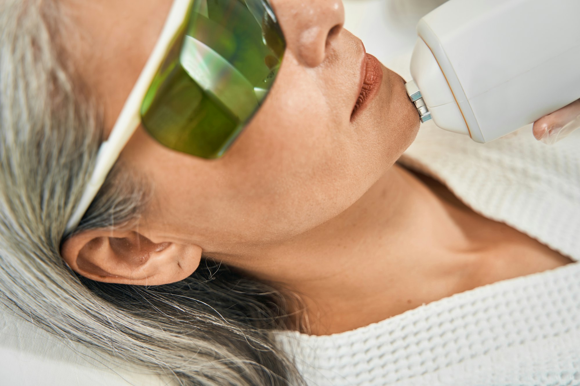 Female patient doing professional face care procedure